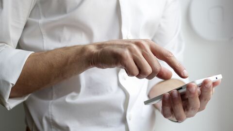 Barrierefreie Apps für alle Mann in weißem Hemd mit Smartphone