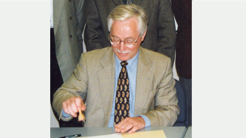 HZD-Chronik_Direktor Leonhard Ermer stempelt Dokument