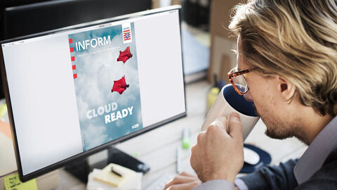 Die INFORM erscheint sowohl als Print- als auch als Onlinemagazin. Ein blonder Mann mit Brille an einem Schreibtisch sitzend, der gerade eine Tasse zum Mund führt, blickt auf den Computerbildschirm vor sich, auf dem das Titelbild einer INFORM-Ausgabe zu sehen ist